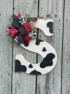 a wooden sign with a cow design on it