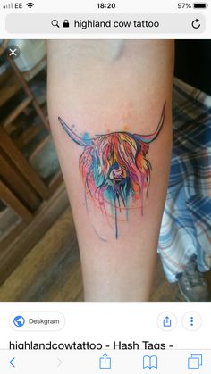 a tattoo on the leg of a person with a cow head painted on it's side