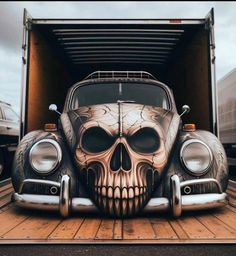 a car with a skull painted on it's hood in the back of a truck