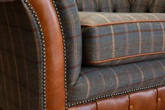 an upholstered leather and tweed couch