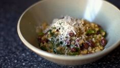 a white bowl filled with food on top of a table