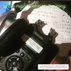 a pair of headphones sitting on top of a table next to a notepad