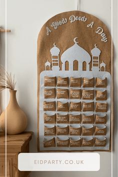 a brown and white wall hanging on the side of a building with coffee bags in front of it