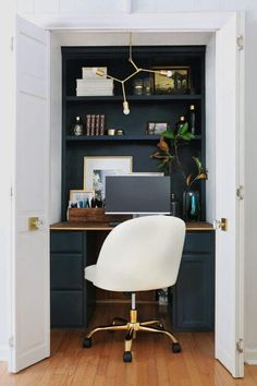 a white chair sitting in front of a computer desk