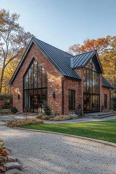 a large brick house with lots of windows on the front and side of it's roof