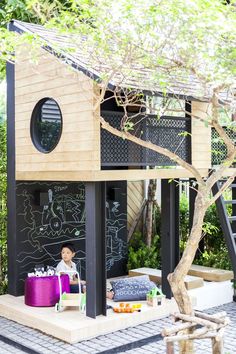 an image of a small house made out of wood with chalkboard on the walls