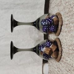 two glass vases with bows on them are sitting on the floor next to each other