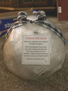 a plastic bag with some dices on it and a sign that says treasure ball game