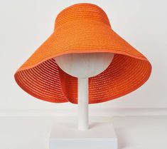 Embrace sunny days with the Poppy roll-up visor, a chic accessory designed to keep you cool and stylish. Perfect for brunch, beach outings, or outdoor weddings, its adjustable feature ensures a comfortable fit, while the charming back bow adds a trendy touch. From Violet and Brooks. Adjustable Packable Sun Hat For Sunbathing, Adjustable Visor Straw Hat For Summer, Adjustable Packable Sun Hat For Beach Season, Adjustable Packable Sun Hat For Beach, Trendy Summer Visor Sun Hat, Summer Sun Hat With Uv Protection Visor, Adjustable Orange Sun Hat For Vacation, Orange Sun Hat For Spring Beach Days, Orange Sun Hat For Spring Beach Outings