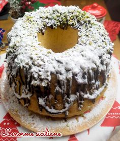 a cake with chocolate frosting and sprinkles sitting on top of a table