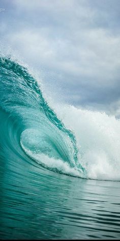 a person riding a wave on top of a surfboard