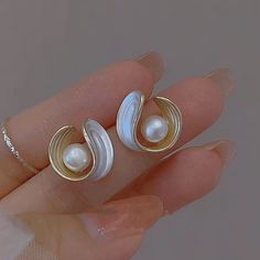 PRODUCT SPECIFICATIONS Pearl type Freshwater pearl / Shell Pearl Pearl shape Round Pearl size 6-7 mm Pearl color White Length 1.5cm * 1.6cm Stock number 7265 Metal S925 silver pin For Female Weight 2 g THIS ELEGANT PEARL STUD EARRING IS TRUE FASHION IN 2024. WITH A PEARL IN THE MIDDLE, WHICH IS SURROUNDED BY A C-SHAPED, ELEGANT LOOP, THE EARRINGS SHOW A NEW VINTAGE STYLE LOOK, AND IT IS EASY TO MATCH ANY OUTFIT. Pearl Earrings The Pearl Vogue, Luxury Pearl White Pierced Pearl Earrings, Beautiful Stud Earrings, Mother Of Pearl Jewelry, Silver Pin, Pearl Types, Pearl Shell, Pearl Stud Earrings, Pearl Color