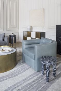 a living room filled with furniture and a fire place next to a wall mounted tv