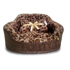 the leopard print dog bed has a gold bow on it's head and is made out of faux material