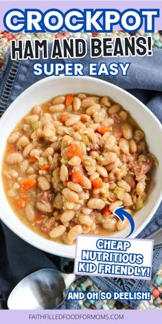 a bowl filled with beans and carrots next to a spoon