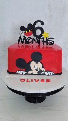 a red and black cake with mickey mouse on top