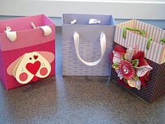 three bags with designs on them sitting on a counter