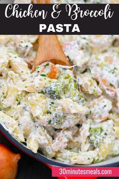 chicken and broccoli pasta in a skillet with a wooden spoon on the side