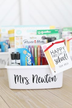 a personalized teacher's gift basket with pens, markers and other school supplies