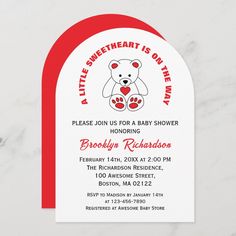 a white and red baby shower with a teddy bear on it's chest,