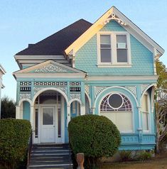 a blue house with white trim on the front door and steps leading up to it