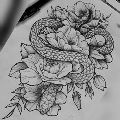 a drawing of a snake and flowers on paper