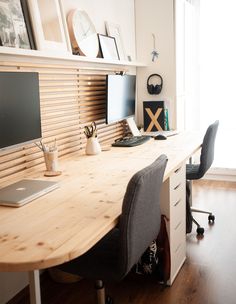 a wooden desk topped with a laptop computer