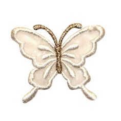 a white butterfly shaped brooch with gold trimming on it's back end