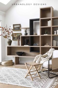 a living room filled with furniture and bookshelves on top of a wooden floor