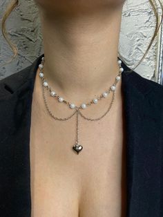 ✨ Description: Add a touch of elegance to your everyday look with this minimalist necklace. Featuring a delicate silver-plated chain, a polished white glass pearl, and a filled heart pendant, this piece embodies simplicity and sophistication. It's the perfect accessory for those who appreciate understated beauty. Materials: Silver-plated chain, white glass pearl, silver-plated heart pendant Design: Minimalist style with a classic yet modern aesthetic Length: Adjustable chain for versatile wear ✨ Why You'll Love It: This necklace is lightweight, versatile, and easy to pair with any outfit. Whether you're dressing up for a special occasion or looking for a subtle statement piece, this necklace will become a timeless addition to your jewelry collection. 🎁 Gift Ready: Packaged beautifully, it Pearl Chain Necklace, Elegant Necklaces, Pendant Design, Pearl Chain, Minimalist Necklace, Jewelry Lover, Minimalist Jewelry, White Glass, Minimalist Fashion