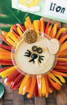 a lion face made out of carrots and crackers on top of a plate