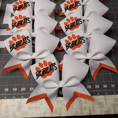 several orange and white bows with the word bears on them