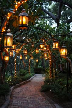 a walkway with lanterns hanging from it's sides and lights on the trees above