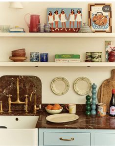 the kitchen counter is covered with plates and bowls, cups, and utensils