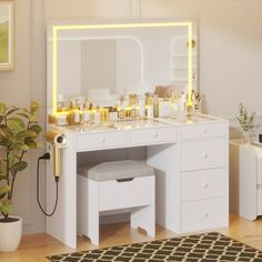 a white vanity with lighted mirror and stools in a room next to a potted plant