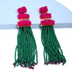 Doll up for your next night out with these dazzling resin tassel drop earrings! These earrings are the perfect accent for any outfit and will make everyone want a pair! With their unique shape and fun tassel detail, these stylish earrings will have heads turning wherever you Trendy Party Tassel Earrings, Green Tassel Earrings For Party, Trendy Beaded Earrings For Party, Chic Beaded Drop Earrings For Parties, Chic Party Beaded Drop Earrings, Summer Party Chandelier Earrings With Tassels, Tassel Drop Chandelier Earrings, Tassel Chandelier Drop Earrings For Parties, Tasseled Chandelier Drop Earrings For Party