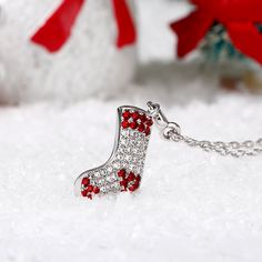 Bright color and classic Christmas stocking design,a good decor to enrich your Christmas Day. Super cute and manufactured with love, this necklace features sparkling red and white stones. Wear your stocking necklace on your neck and carry the spirit of the season with you wherever you go with the sterling silver Christmas stocking necklace.Carat Weight: 0.573 ctStone Size: 2,1.25,1.1,0.9,0.9,1.1 mmStone Type: Jeulia® StoneNumber of Stones: 55 Stone Shape: RoundStone Color: Diamond White, Garnet Red Christmas Party Necklaces, Red Necklaces For Valentine's Day Festive Occasions, Red Necklace For Valentine's Day Festivities, Red Christmas Jewelry Gift, Red Jewelry Christmas Gift, Red Jewelry For Christmas Gift, Elegant Red Christmas Necklace, Elegant Red Necklace For Christmas, Festive Red Christmas Necklaces