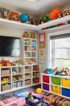 Colorful and organized children's playroom with toys, books, and games on shelves and in bins. Playroom Wall Storage, Organization Ideas For Toys, Wall Toy Storage, Playroom Toy Storage Ideas, Daycare Decorations, Boy Toy Storage, Farmhouse Dinnerware Sets