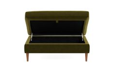 the back of a green couch with an open box on it's seat and legs