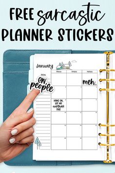 a woman's hand pointing at a planner with the words free printables on it