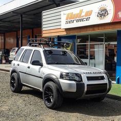 a silver suv parked in front of a building