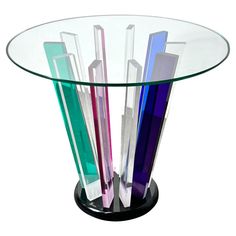 a glass table with different colored sticks sticking out of it