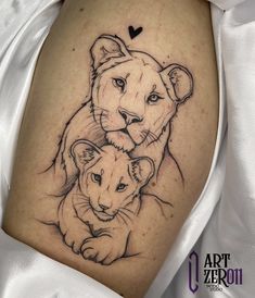 a woman's thigh with a drawing of two lions and a heart on it