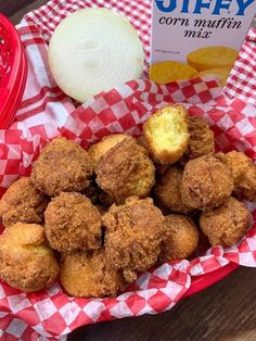 some fried food on a red and white checkered table cloth next to a book