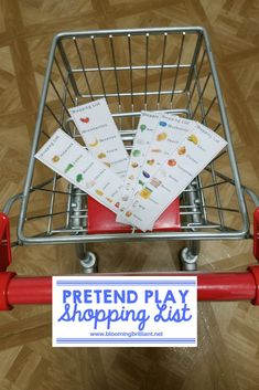 a shopping cart with some cards in it and the words pretend play shopping list on top