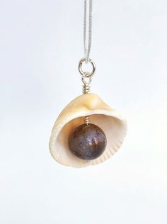 This is a wonderful pendant made of a natural Atlantic seashell and natural Agate. My seashells are harvested on Melbourne beach in Florida. The inner shell has beautiful pink and purple color to it and looks very authentic in combination with agate. The pendant makes a great souvenir from Florida for ocean lovers and sustainable friends.Agate is well known for its calming, soothing effects on the mind, primarily when used over some time. It can help enhance mental clarity and improve concentrat Ocean-inspired Abalone Shell Gift, Spiritual Shell Necklace Gift, Pearl Pendant Shell Gift, Pearl Pendant Shell As Gift, Spiritual Shell Necklace With Natural Stones For Gift, Gift Shell Necklace With Natural Stones, Handmade Natural Shell Necklace For Gift, Natural Stones Shell Necklace Gift, Natural Shell Necklace As Gift