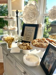 there is a buffet table with cookies and pastries on it