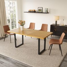 a dining table with four chairs and a vase filled with flowers on top of it