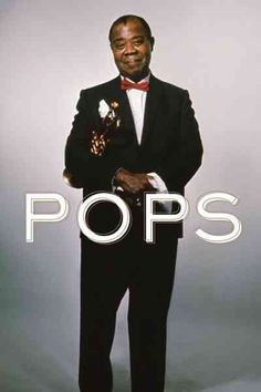 a man in a tuxedo and bow tie posing for a photo with the words pops above him