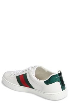 Signature web stripes and bold embroidery bring together two of Gucci's most distinctive house codes on this classic leather sneaker. Contrasting heel tabs are a modern reference to the brand's official colors. Style Name:Gucci New Ace Sneaker (Men). Style Number: 5415061. Gucci Luxury Sneakers With Contrast Sole, Classic Sneakers With Embroidered Logo And Round Toe, Gucci Sneakers With Contrast Sole For Streetwear, Gucci Luxury Sneakers With White Sole, Luxury Gucci Sneakers With White Sole, Classic High-top Sneakers With Embroidered Logo, Sporty Gucci Sneakers With Contrast Sole, Gucci Low-top Sporty Sneakers, Gucci Sporty Low-top Sneakers